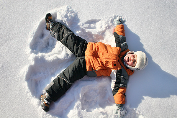 Child making snow angels