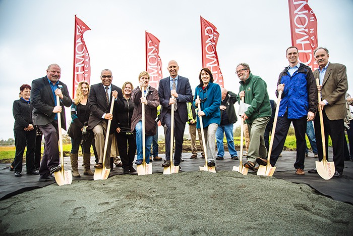 Group of city officials holding shovels at groundbreaking event