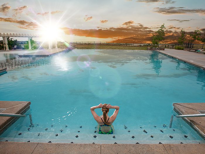 Woman relaxing in community pool