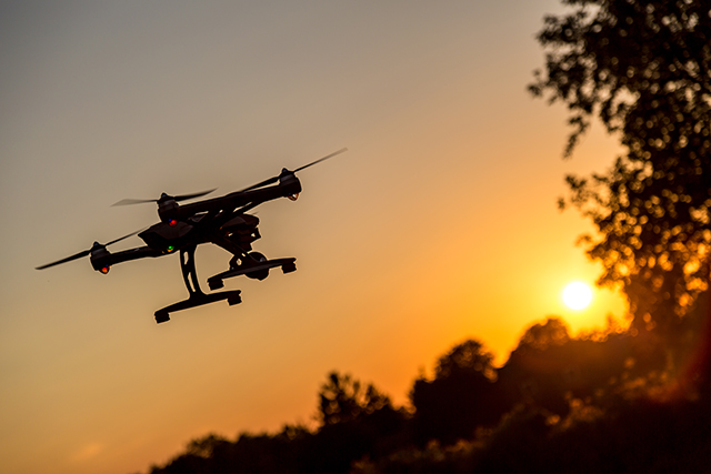 Drone flying at sunset