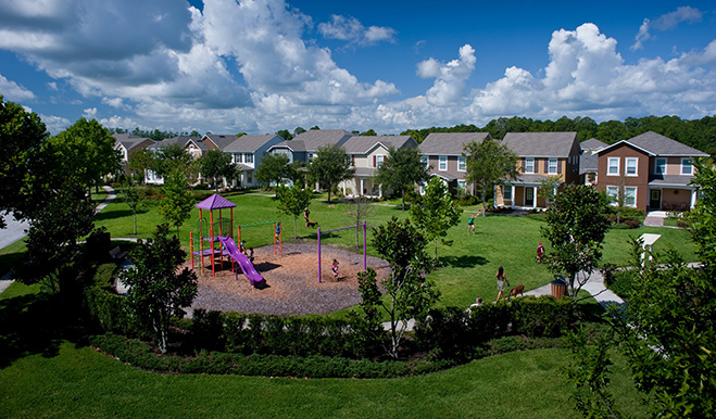 Playground in the foreground; single-family homes in the background