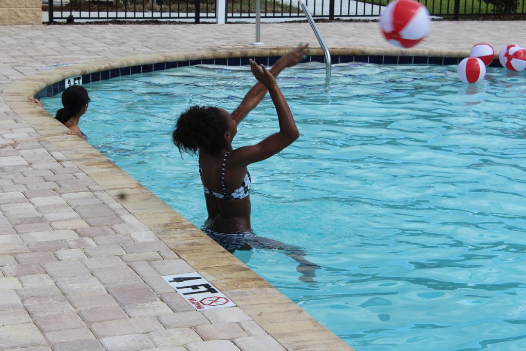 Guests enjoying the community swimming pool at a recent Open House in Florida.