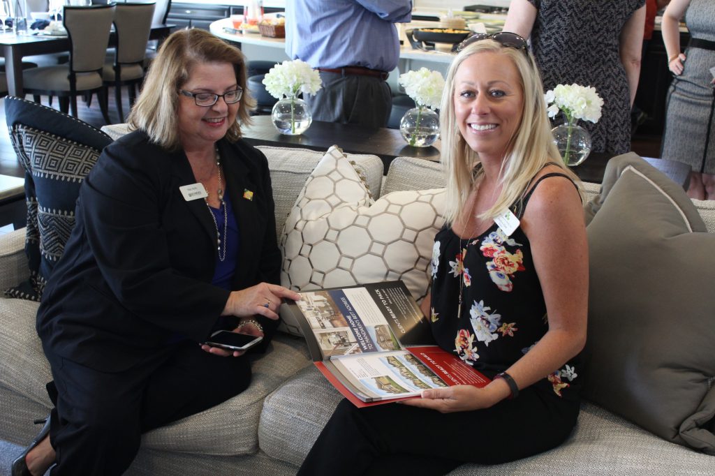 Richmond American sales associate discussing a new community's floor plans with a local real estate agent