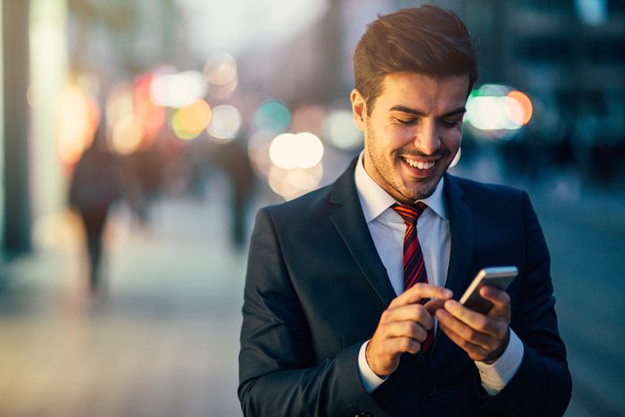 Man typing on cell phone