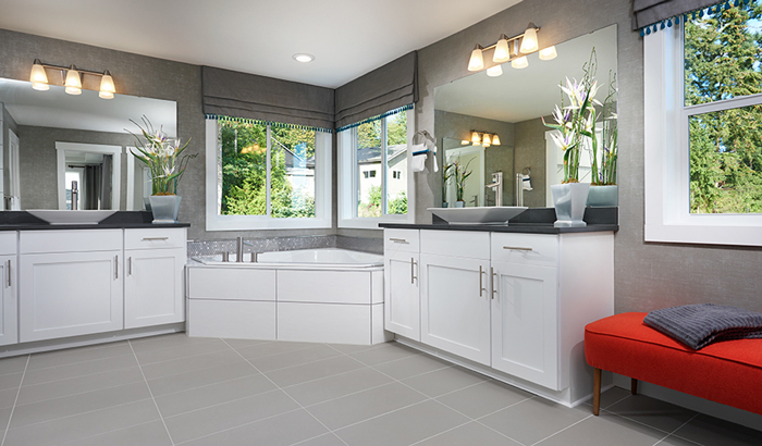 Primary bathroom with white cabinets and soaking tub