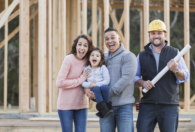 Family of three touring home under construction with superintendent