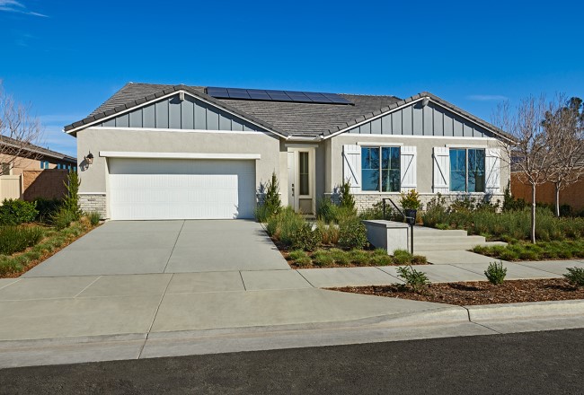 Exterior of ranch-style home with solar panels on roof