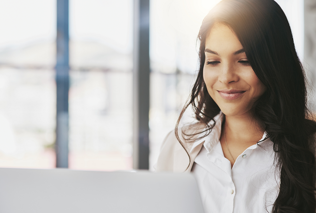 Woman smiling because she's sharing our real estate stories online.
