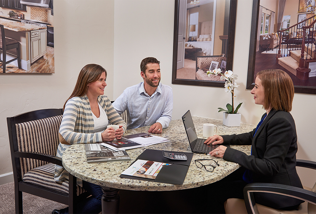Homebuyers talking with representative