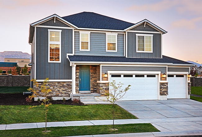 Exterior of two-story Bedford home with 3-car garage