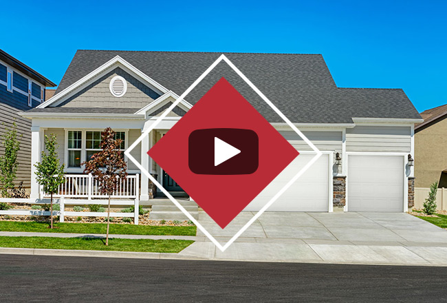 Exterior of ranch-style home with video play button over it