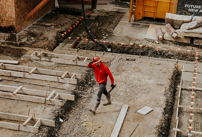 Man in hard hat walking through construction zone