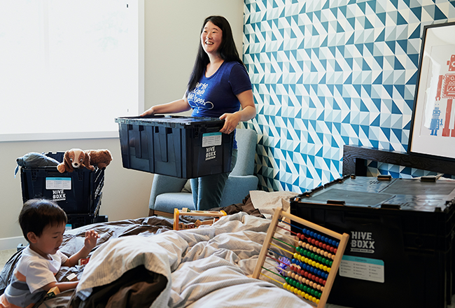 Woman packing belongings in bins