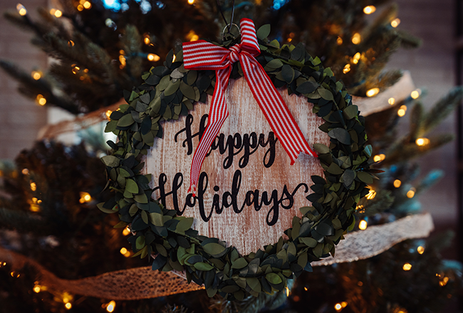 Wreath with happy holidays message in center