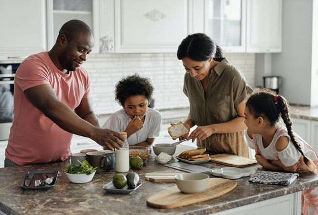 Family preparing food at a kitchen island