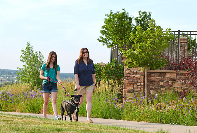 Mother and daughter walking their dog