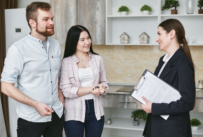 Couple talking with real estate agent