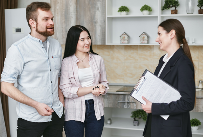 Man and woman speaking with real estate agent