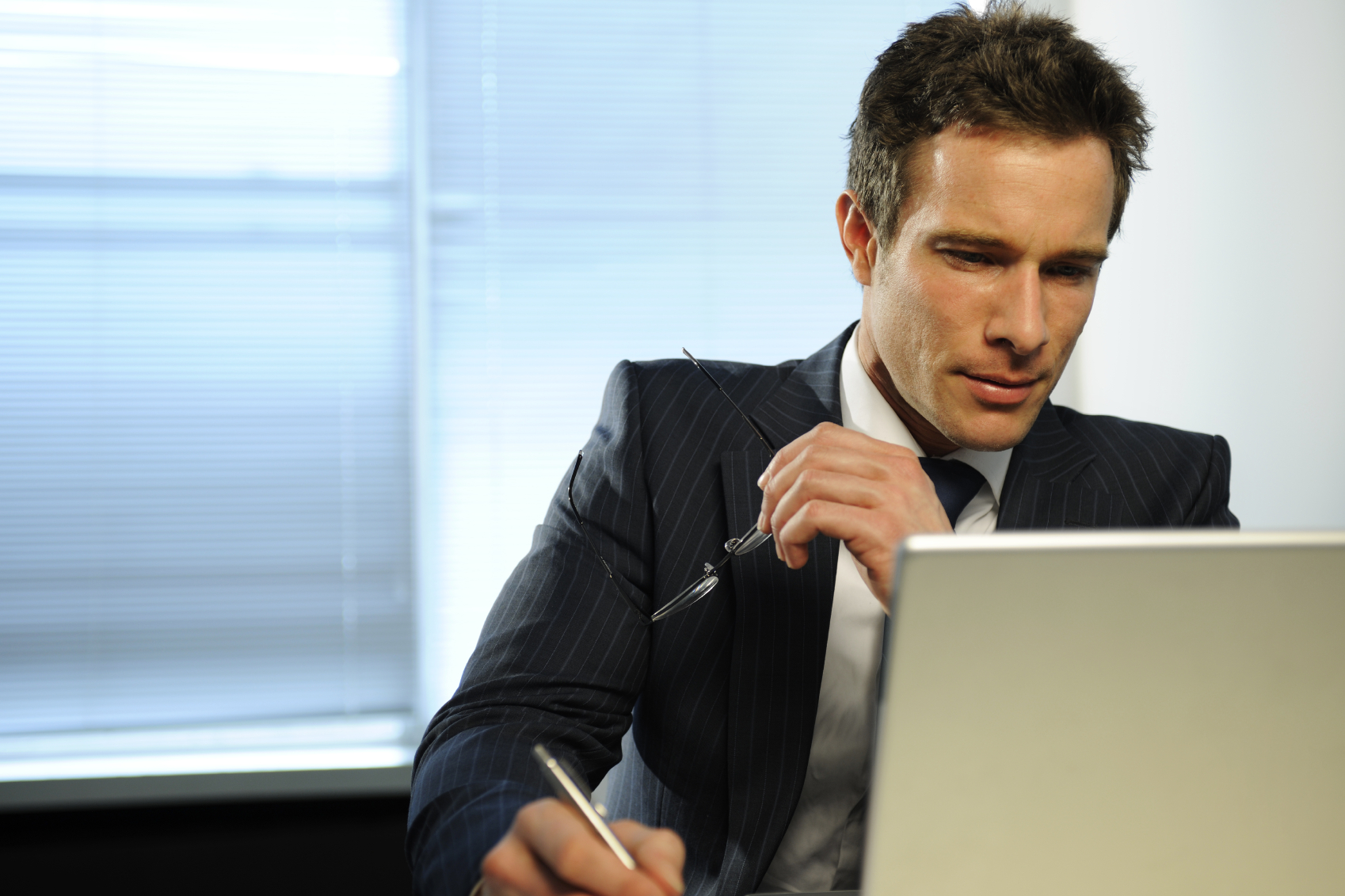 Real estate agent looking at computer screen