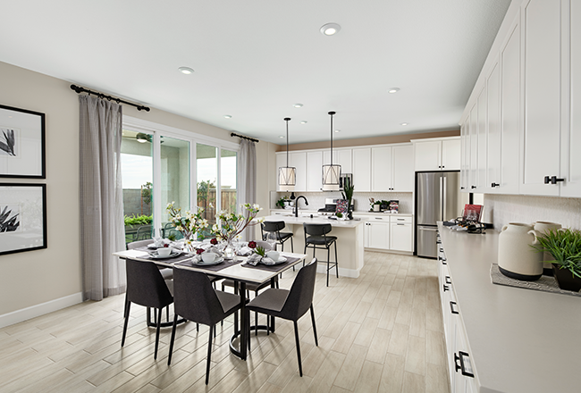 Kitchen with white cabinets and dining table