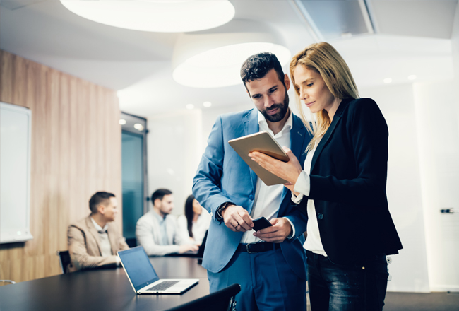 Man and woman viewing real estate content on tablet