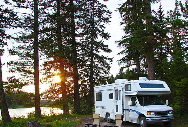 RV parked at campsite in the woods