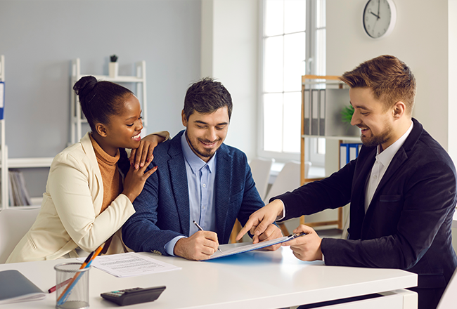 couple chatting with a real estate agent, learning about special offers
