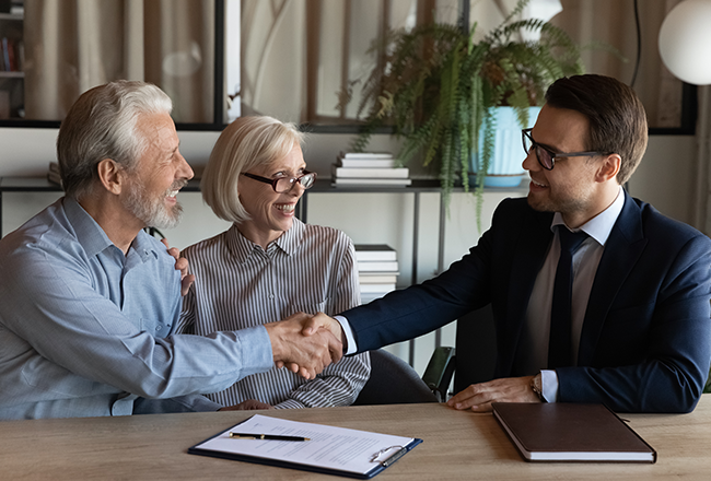 Agent earning real estate commission, shaking hands with happy clients