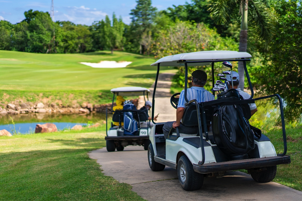 Golf carts driving through a golf course