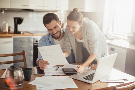 Couple reviewing finances at the kitchen table