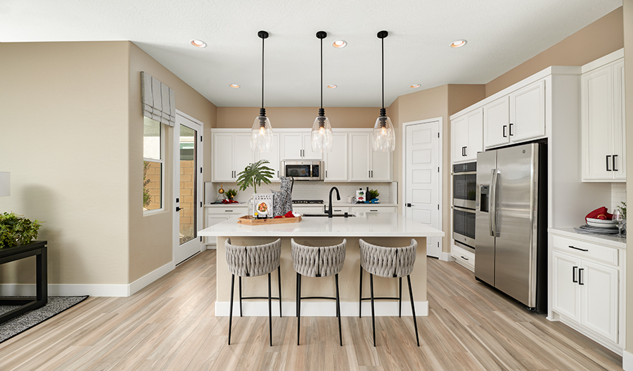 Kitchen with a white center island and white cabinetry