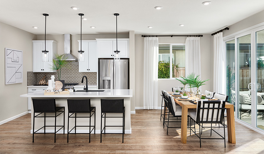 An elegant kitchen and adjacent dining nook in a Citrine Seasons™ Collection home
