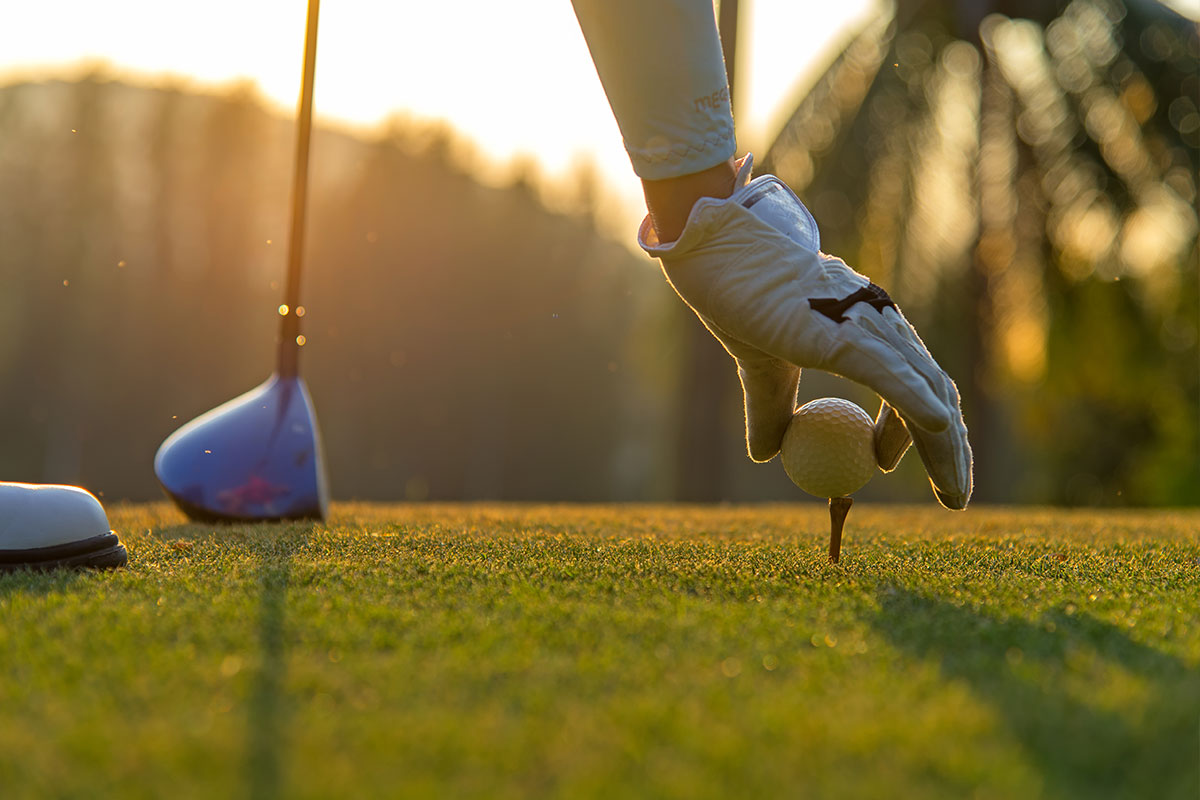 Golfer teeing up 