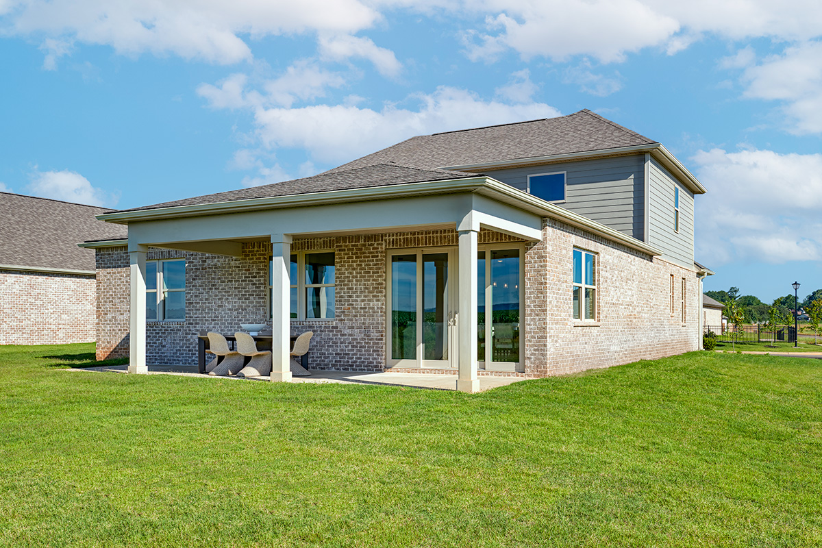 The backyard of a home with a dynamic two-story floor plan
