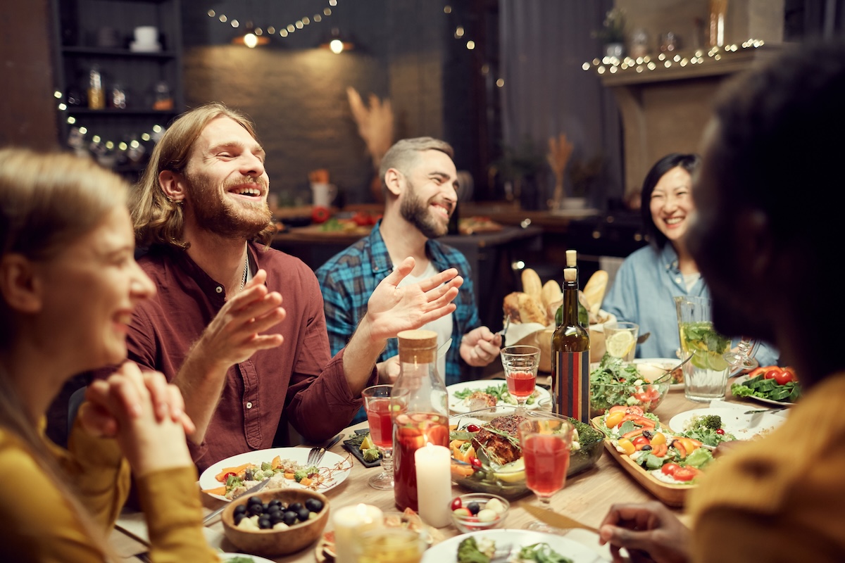People laughing at dinner after exploring homes for sale in San Bernardino County