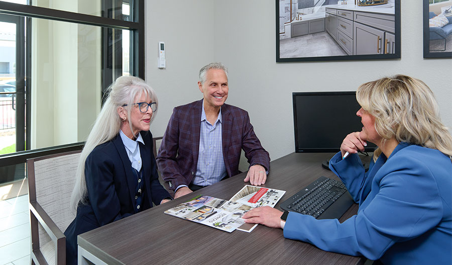 Real estate agency talking to an older couple