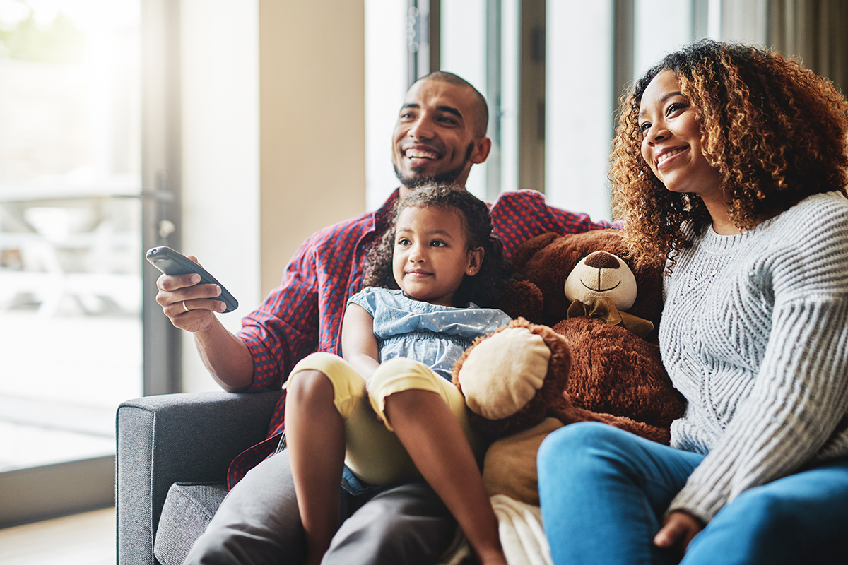 Family enjoying television on a couch together