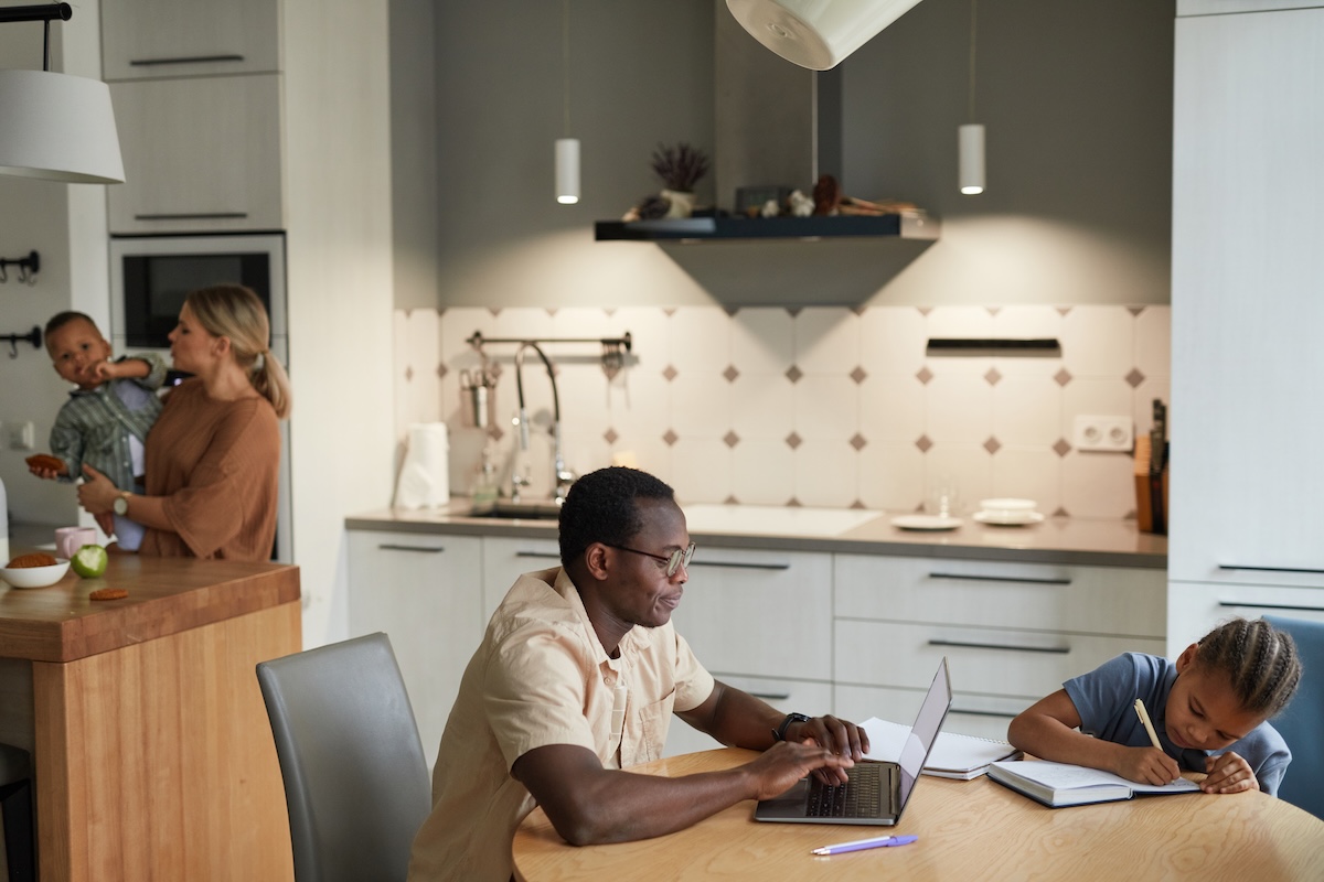 Man using a laptop computer at his kitchen table
