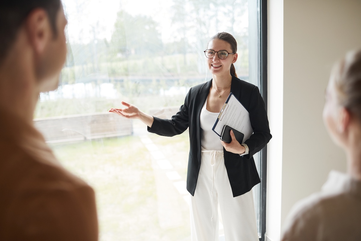Female realtor showing a house to a couple