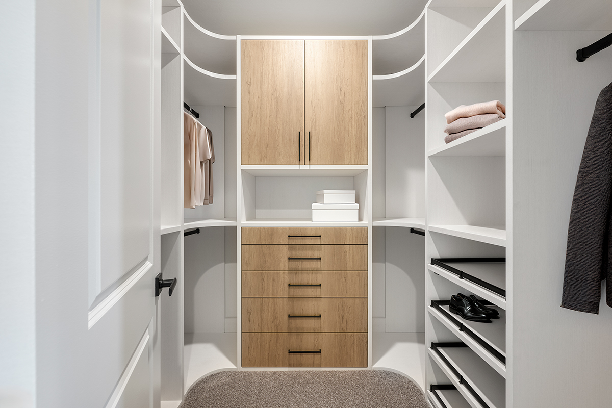 A large walk-in closet with ample drawers and other storage