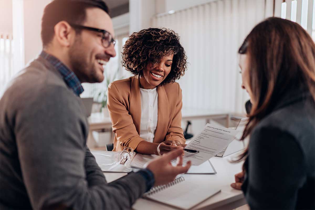 A couple of homebuyers chatting with a loan officer