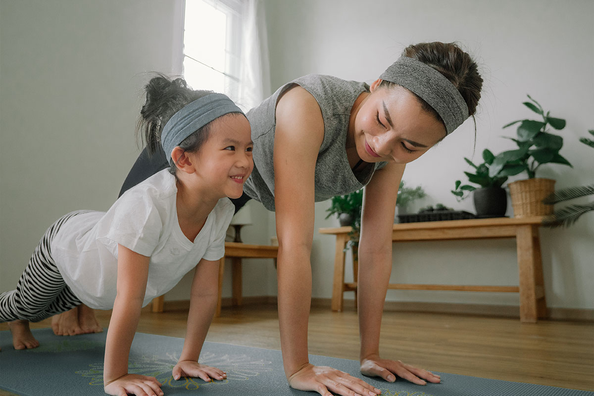 A mom doing at-home yoga with her child