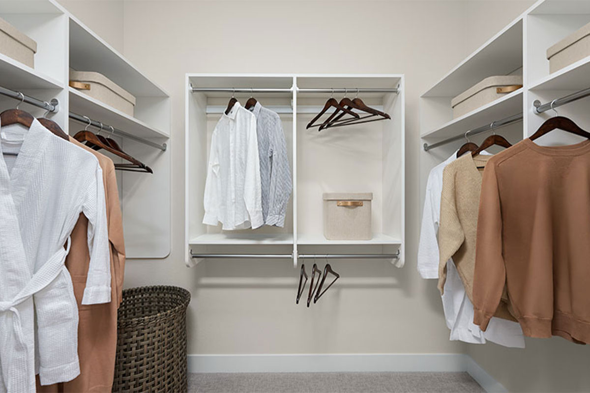 Clothing neatly organized in a walk-in closet