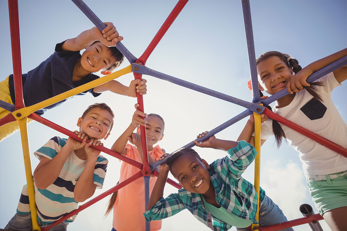 Kids playing on a playground jungle gym