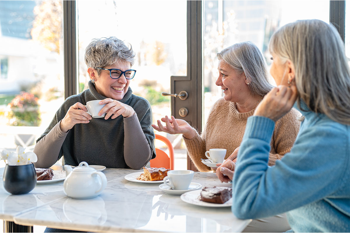 A group of older adults enjoying refreshments at a community cafe