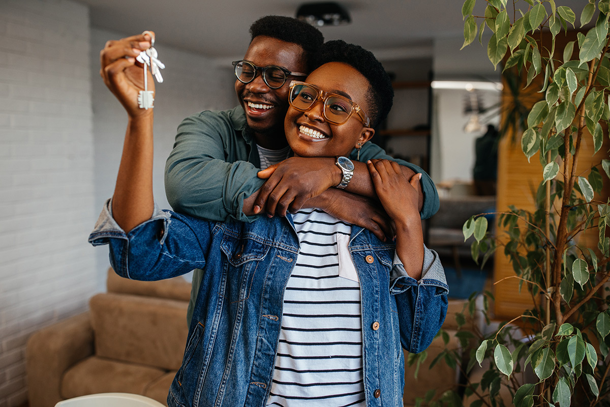 Young couple holding the keys to their new home