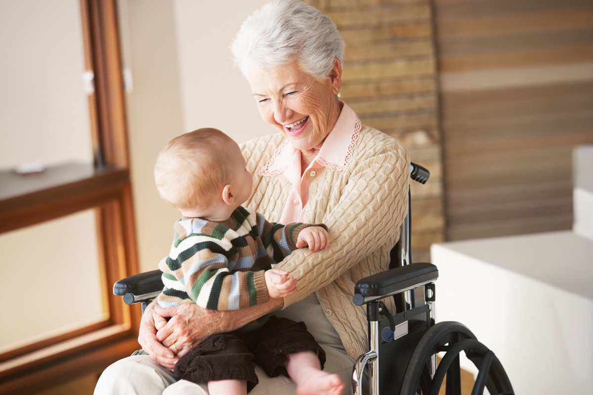 Grandmother in wheelchair playing with grandson