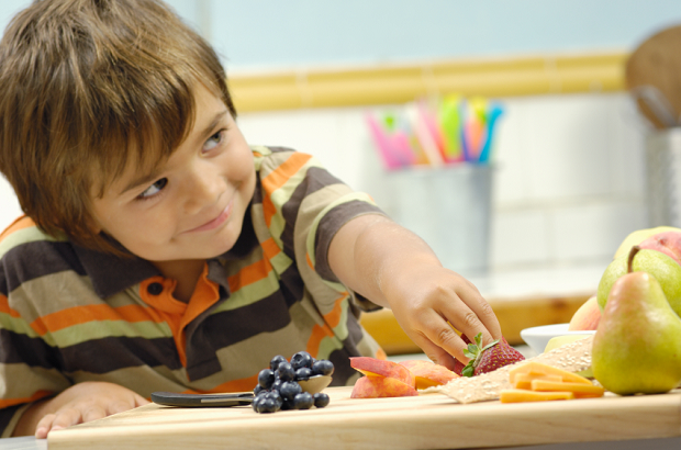 Boy reaching for healthy snack