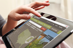 Hand navigating RichmondAmerican.com on a tablet