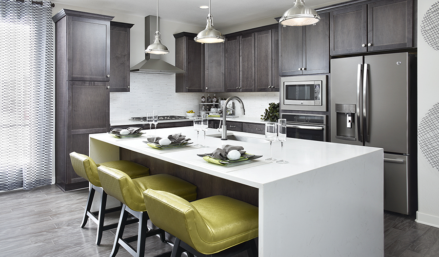 Kitchen with dark cabinets, white island and lime green barstools
